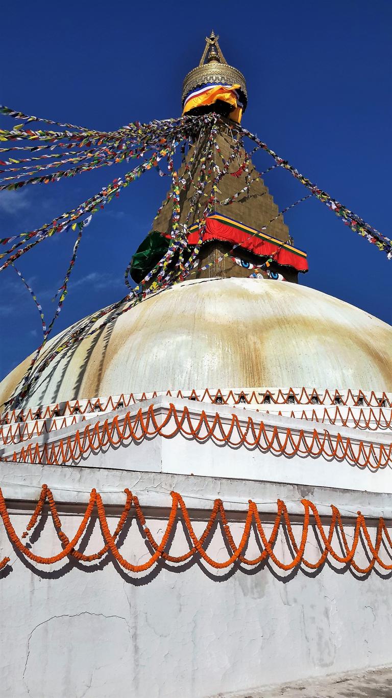 Ein vierstufiger Sockel, der vom Grundriss her einem tibetischen Mandala ähnelt, bildet den Sockel der Stupa. Über Treppen erreichen die Pilger den glockenförmigen Bau. Darauf ruht ein 13stufiger Turm, der sich mit zunehmender Höhe verjüngt. Die Spitze des Turms bildet ein Schirm. Symbolisch steht der Turm für die 13 Stadien der Erkenntnis, die zur Erleuchtung führen. Die Augen des Buddha sind ebenso an den vier Seiten des Turmes angebracht wie das dritte Auge, das für die Erkenntnis steht.